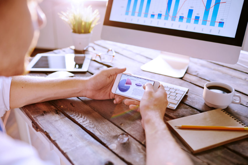 Marketing data in smartphone being analyzed by employee